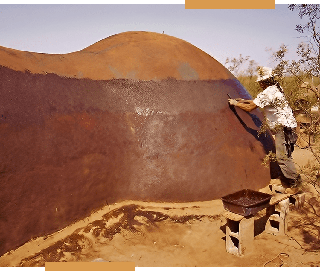 Person working on large earthen structure.
