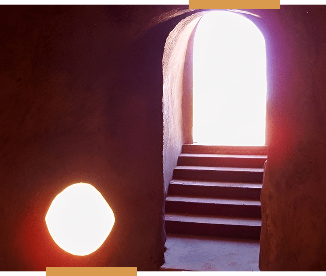 Sunlit doorway and stairs in dark room.