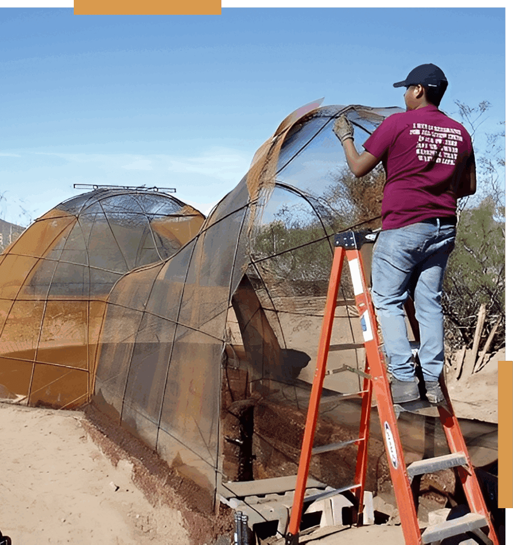 Person building arched structure with netting.